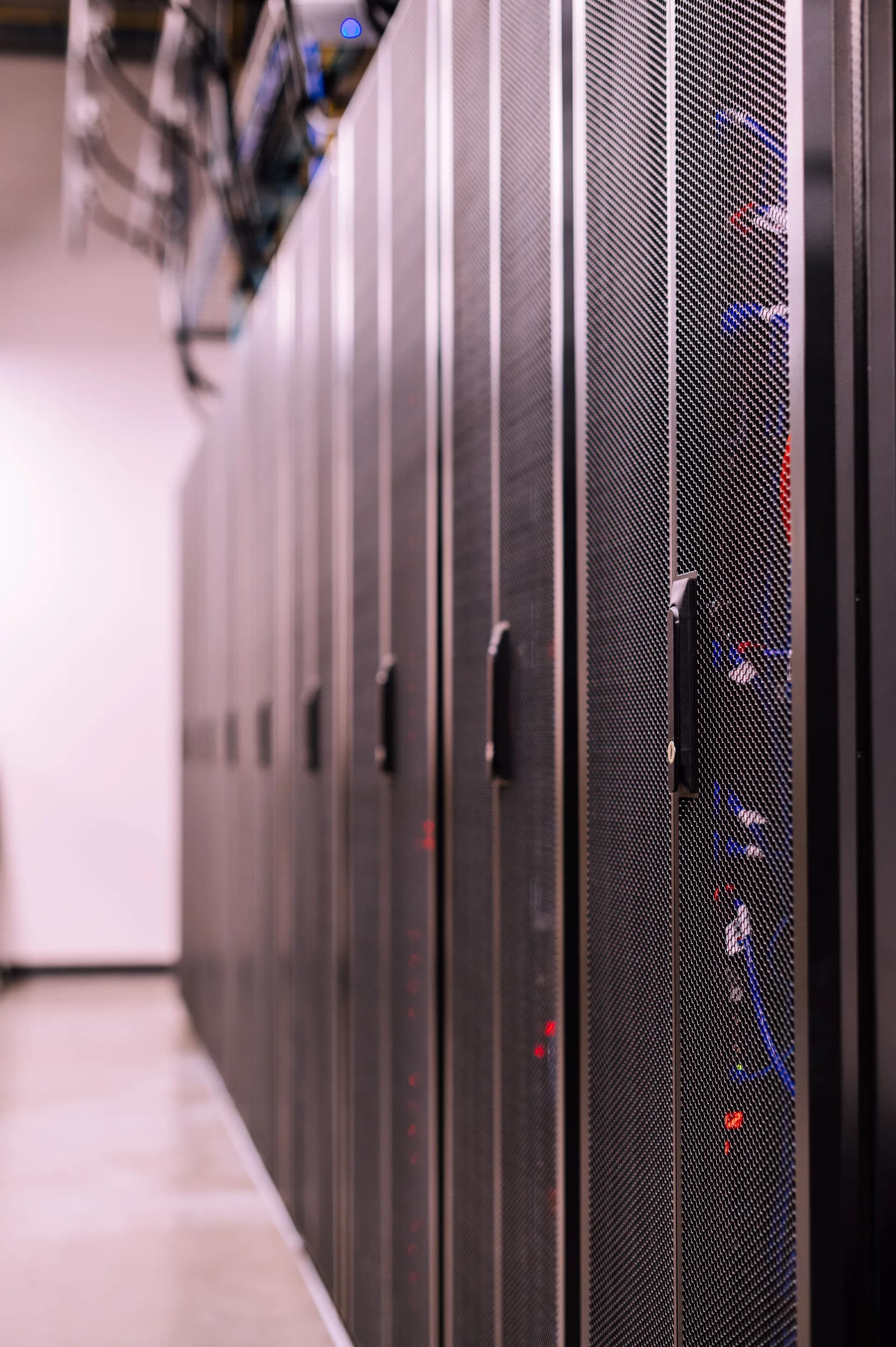 Aisle of server racks with cabling visible